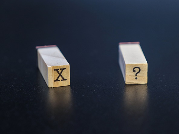 Wooden blocks with an 'X' and a '?'